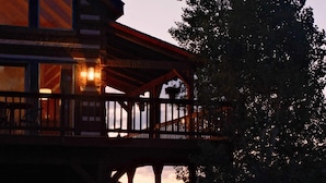 A two-story wooden building with a balcony, large windows, and a view of the landscape. - Hillside Cabin - Mt Views - Patio Decks - Hot Tub (Cascade)
