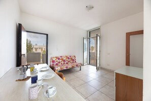 Apartment, Balcony, City View | Living area | 32-inch TV with cable channels