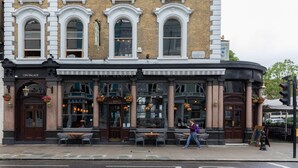 A historic building with a pub named "The Leuine" and a restaurant called "Gin Palace" on the ground floor. - Codrington Mews III by Onefinestay (London)