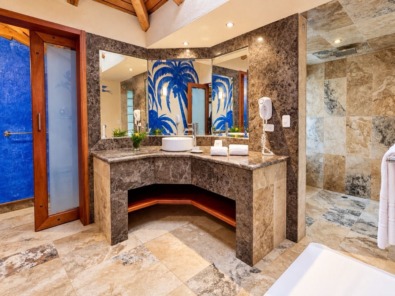 A modern bathroom with a curved vanity, a large mirror, and a shower area.