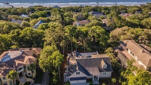 An aerial view of a coastal residential area with houses, dense greenery, and a beach in the background. - Villa w/ Golf Views! Pool, Near Beach Hilton Head (Hilton Head Island)