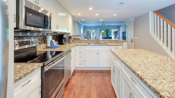 A modern kitchen with granite countertops, stainless steel appliances, and a view of the outdoors. - Villa w/ Golf Views! Pool, Near Beach Hilton Head (Hilton Head Island)
