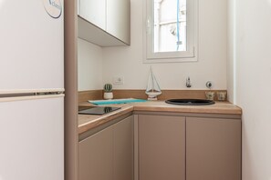 Fridge, electric kettle, cookware/dishes/utensils, dining tables
