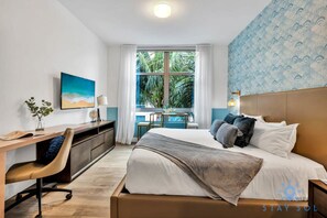 A hotel room with a bed, desk, chair, and a view of the outdoors. - Best Stay Rooftop Pool Hot Tub Hollywood Beach (Hollywood)