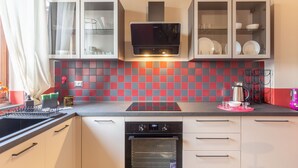 A modern kitchen with a microwave, oven, and cabinets. - Urban House - 301 in Monza (Monza)