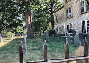 A cemetery with headstones and a wooden fence. - In home mini wing private space. 💜Stay at Hal's Salem, MA (Salem)