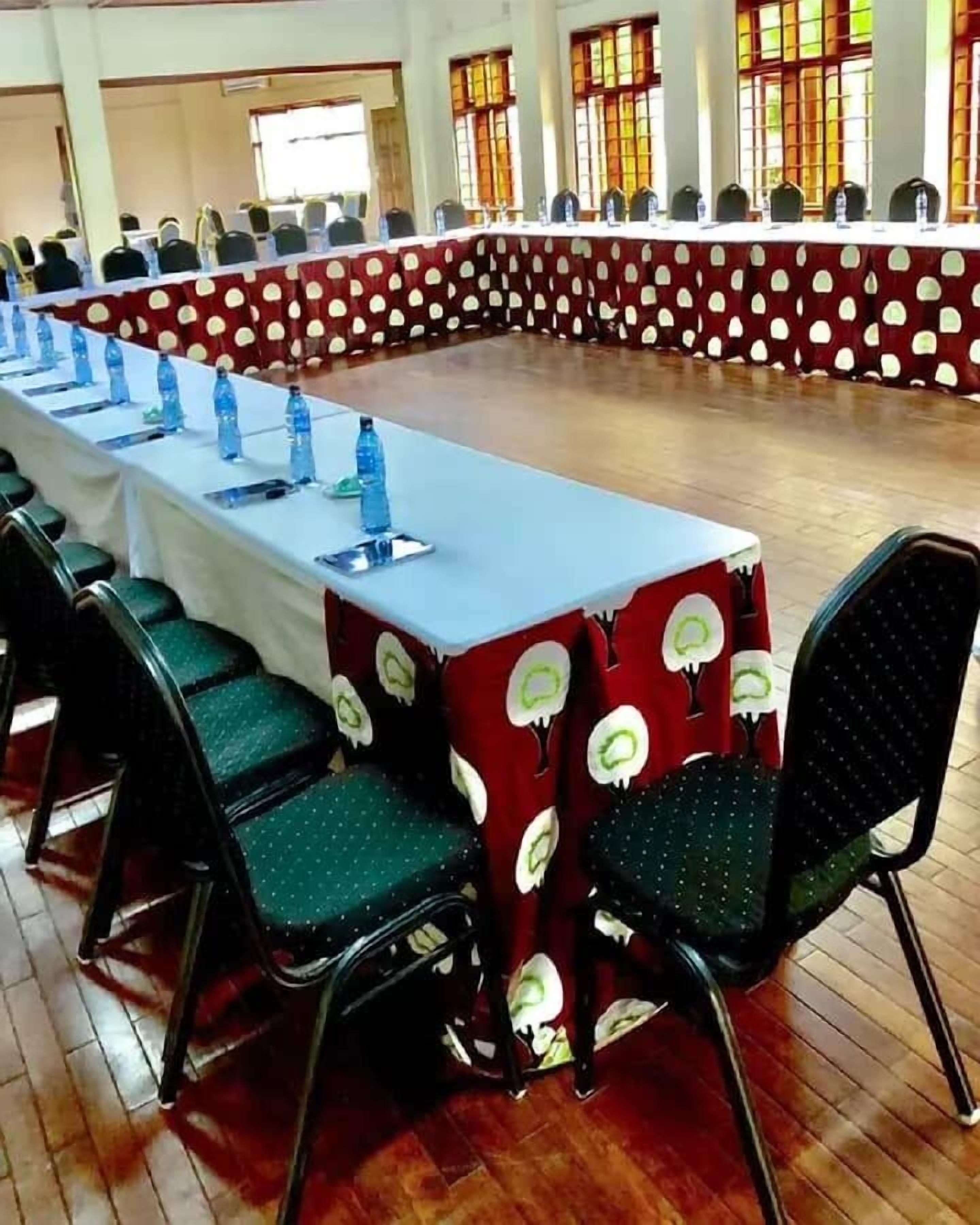 A conference room with a long table, chairs, and water bottles.