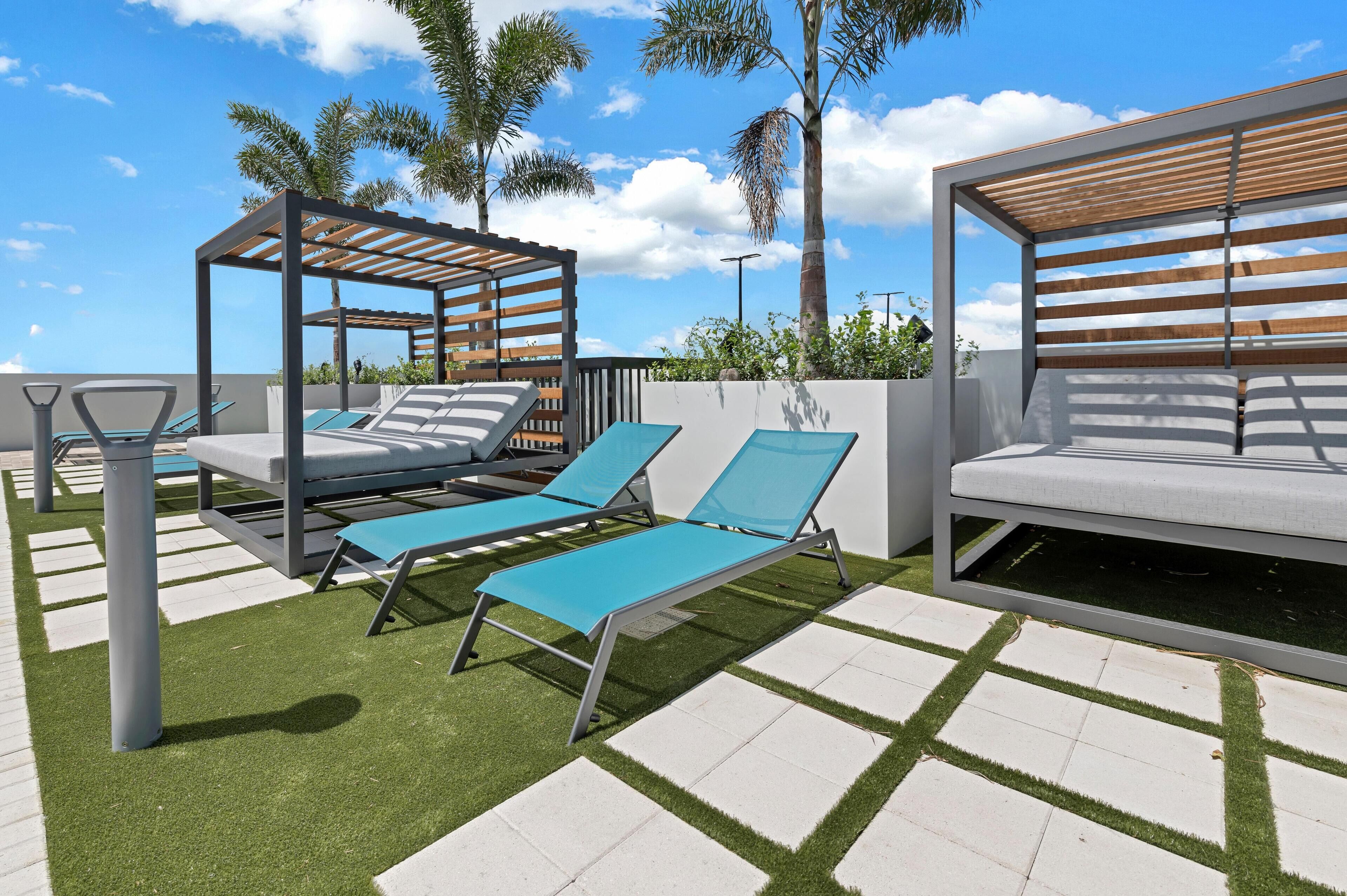 A poolside area with lounge chairs and a pergola structure.
