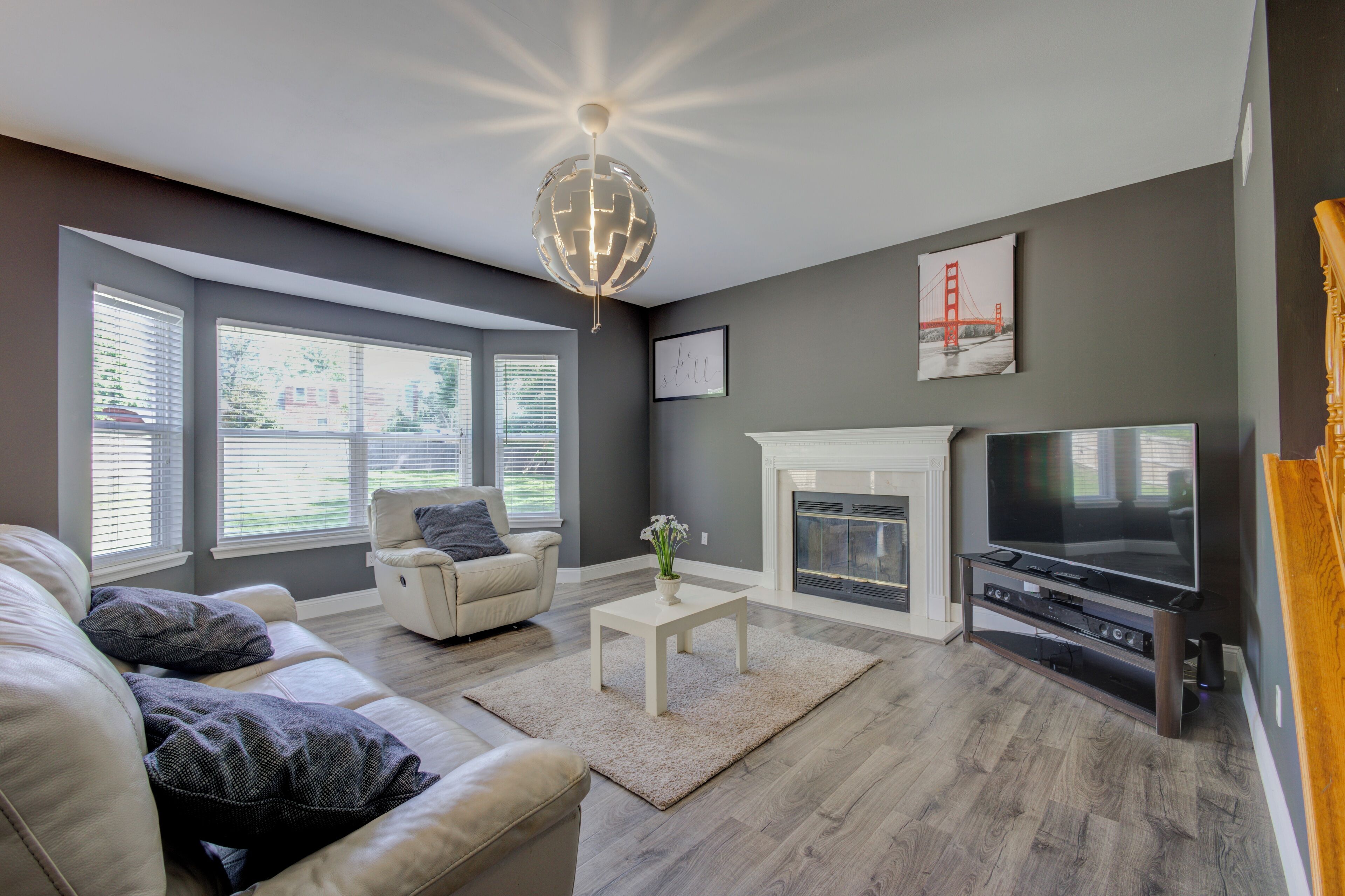 A living room with a fireplace, a television, and a sofa.