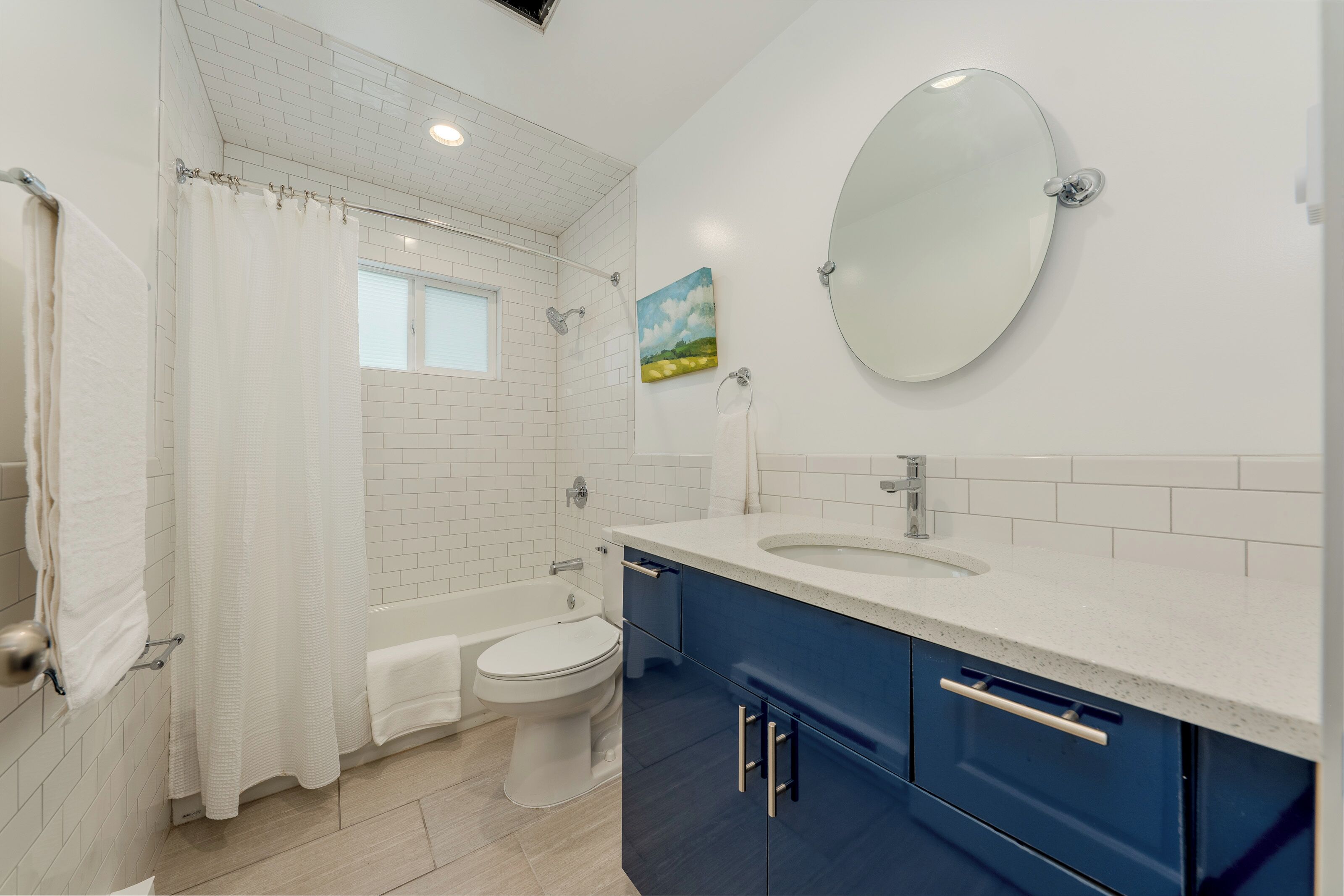 A bathroom with a bathtub, toilet, and sink.