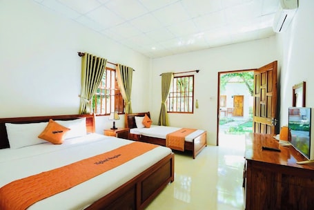 Deluxe Triple Room, Garden View | Desk, laptop workspace, free WiFi, bed sheets