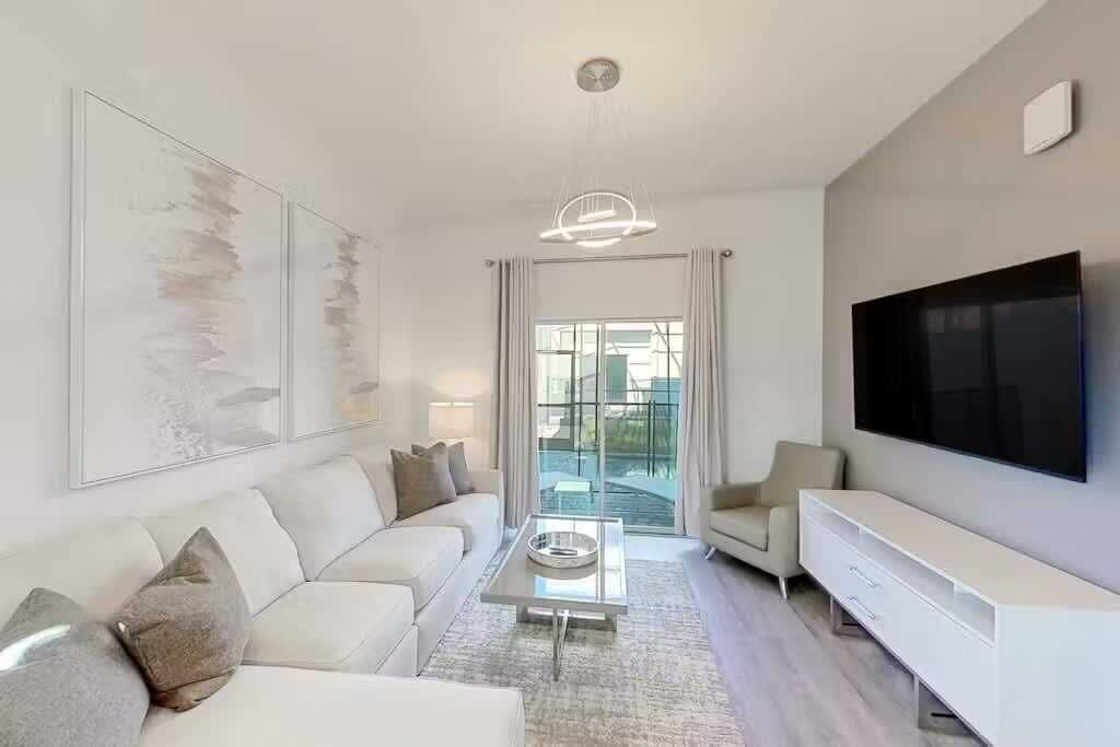 A modern living room with a sofa, coffee table, and TV.