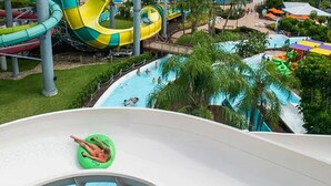 A water park with multiple slides and a pool area.