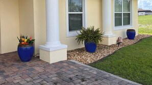 A house with a yellow exterior, white columns, and a brick pathway leading to the entrance. - Disney and Universal Studios only 30 minutes away (Eagle Lake)