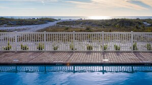 A swimming pool with a view of the beach and dunes. - Treasure Island Escape: 2BR Beach Views (Treasure Island)