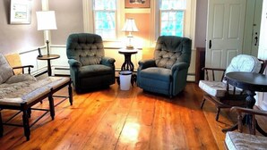 A cozy living room with two armchairs, a sofa, and a small table with a lamp. - Discover the charm of HEWORL: Tonset Treasure, (Orleans)