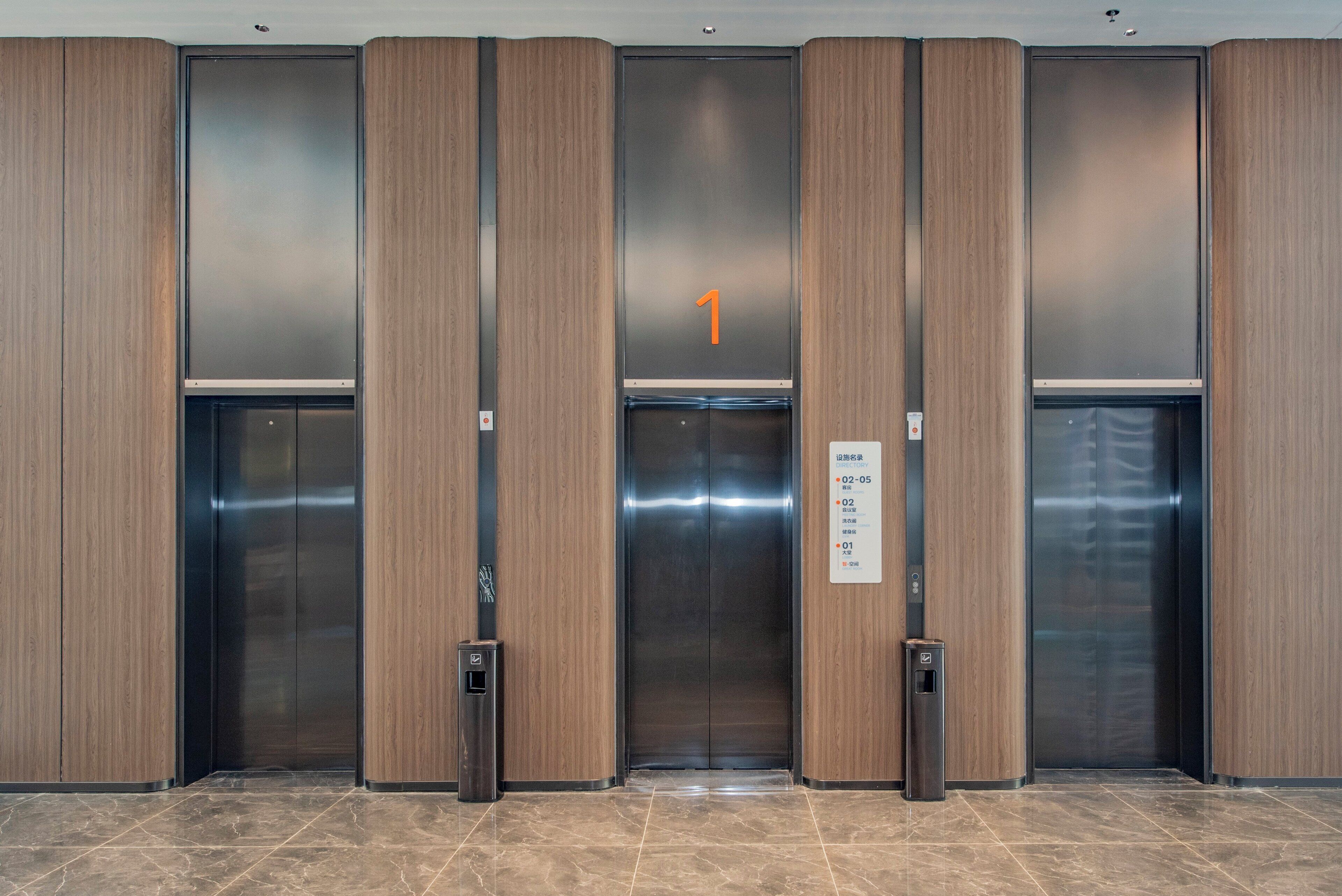 A modern elevator with a digital display showing the number 1.