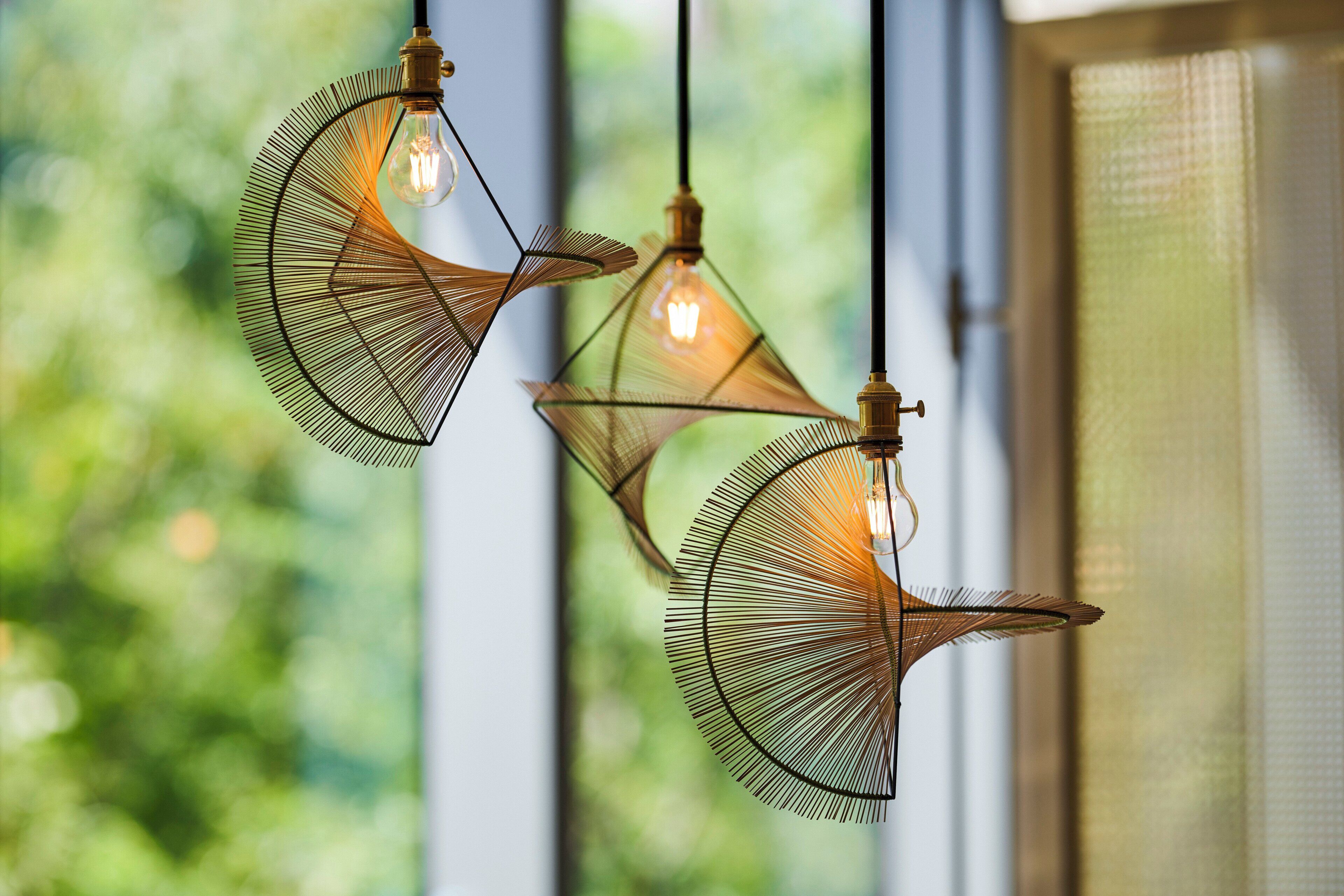 Three hanging pendant lights with a geometric design, suspended from the ceiling.