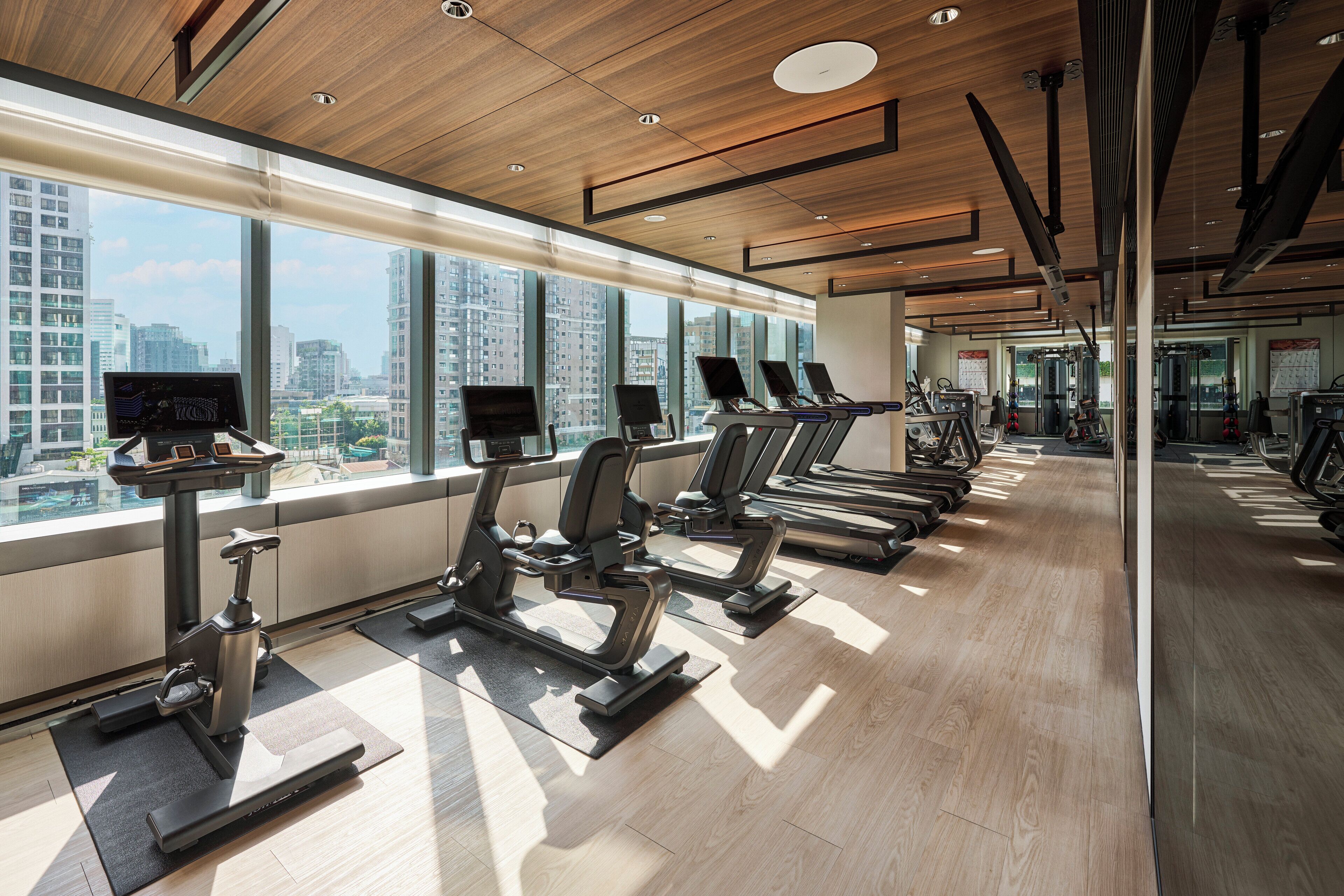 A gym with treadmills, stationary bikes, and weight machines.