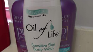 A bottle of Oil of Life Sensitive Skin Body Wash on a bathroom counter. - Peabody Backhouse 5 (Memphis)
