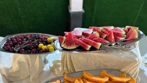 A fruit display with various fruits including watermelon, grapes, and cantaloupe. - Villaggio Stella Maris (Giugliano in Campania)