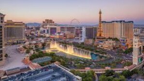 A cityscape with a prominent tower and a river. - Grand Desert 1 Bedroom Suite, Las Vegas! (Las Vegas)