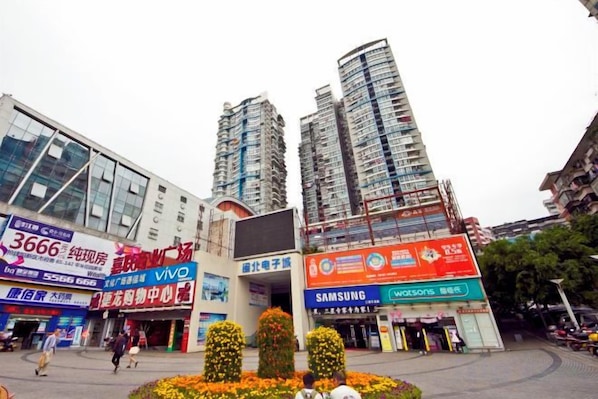 A commercial area with high-rise buildings, a Samsung store, and a 3666 store.