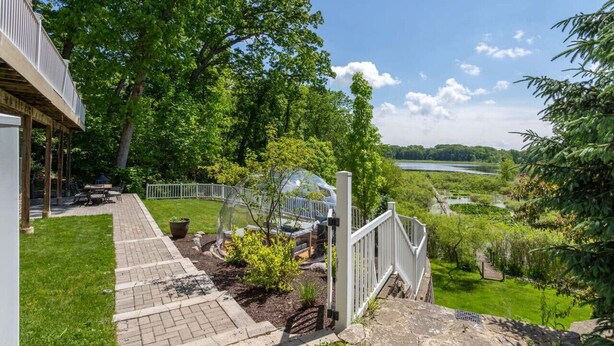 A house with a covered outdoor area, a paved pathway, and a view of a lake. - Lake retreat with unique dome near Indiana Dunes (Valparaiso)