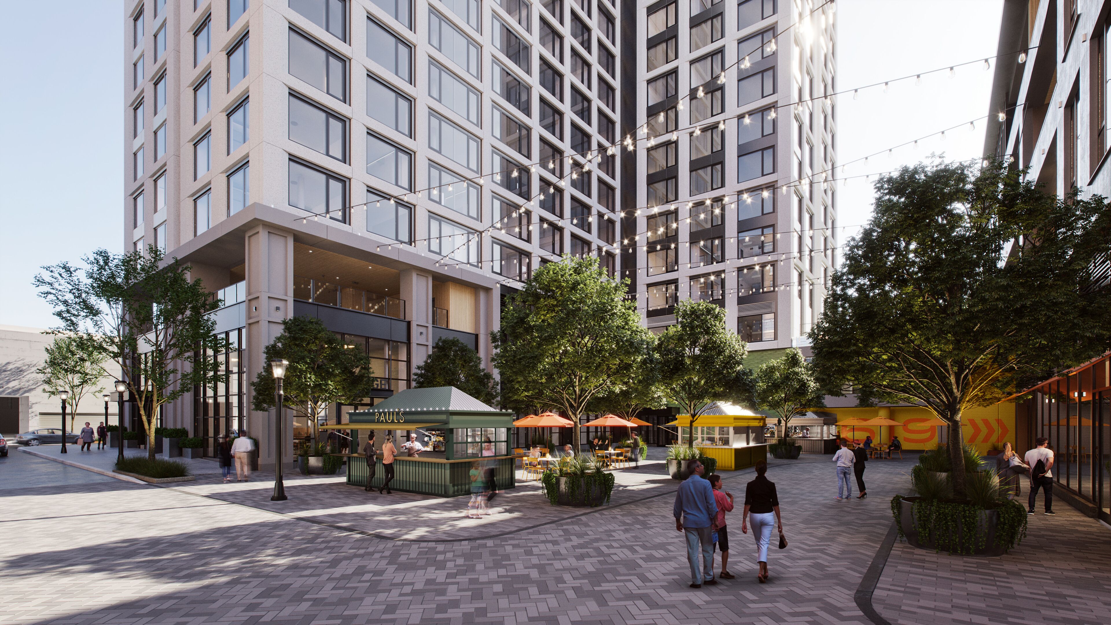 A modern urban plaza with a high-rise building, outdoor seating areas, and pedestrian pathways.