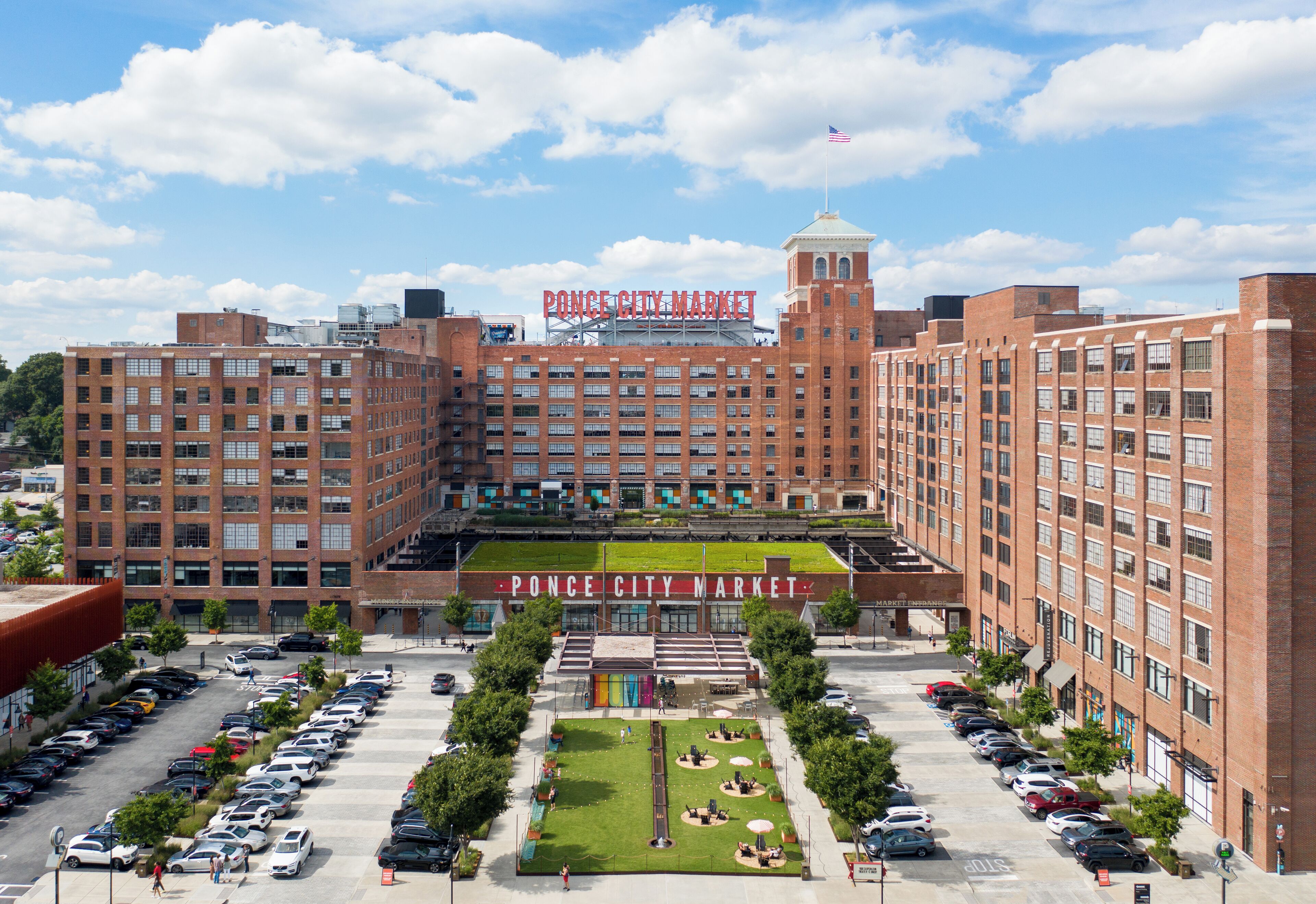 A large brick building with a central courtyard and a sign reading "Ponce City Market".
