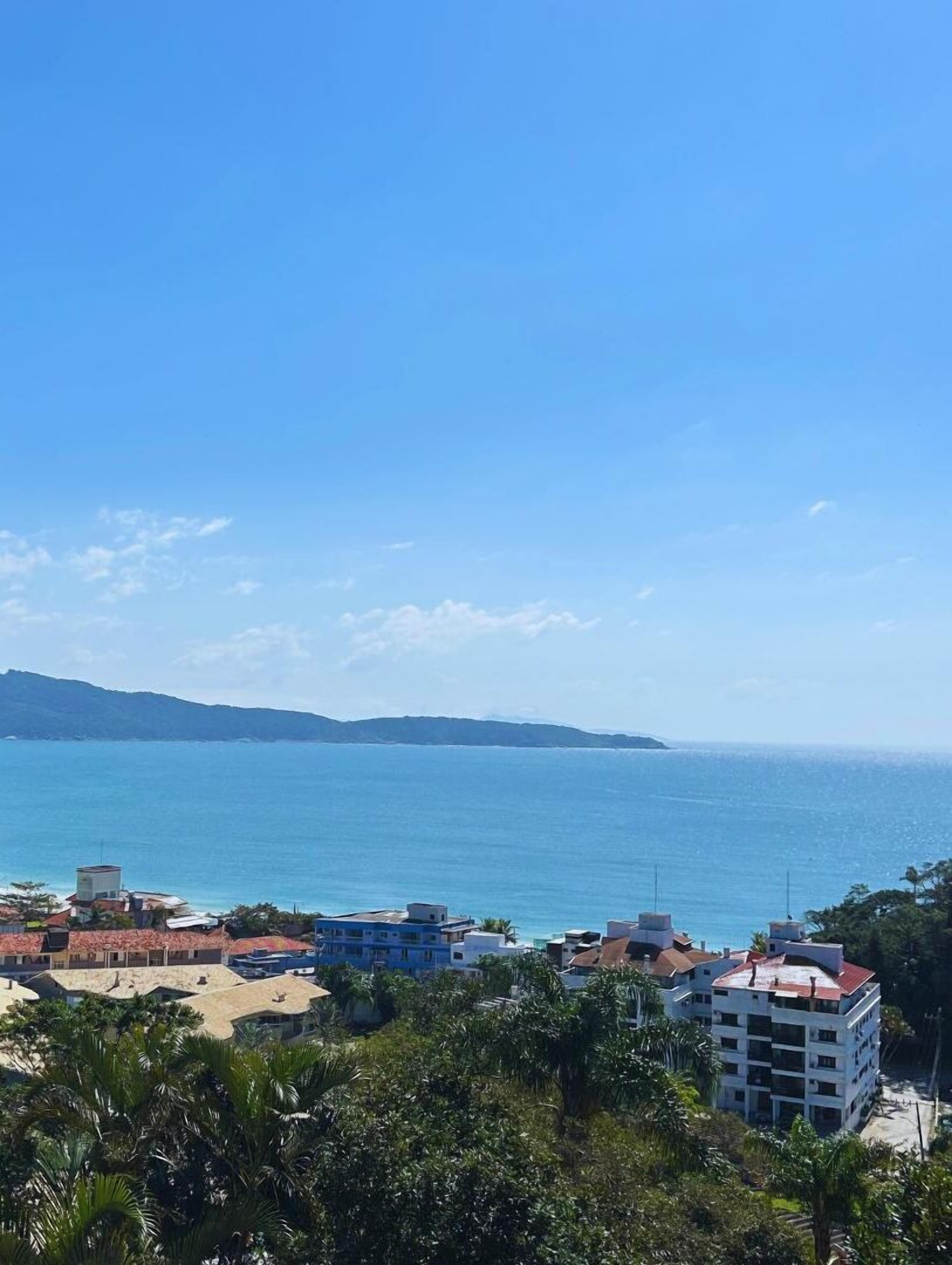A coastal view with buildings and a clear blue sky.