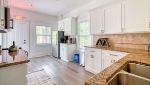 A modern kitchen with white cabinets, granite countertops, and stainless steel appliances. - Victorian Vibes • 3BR • Steps to Mississippi (Portland)