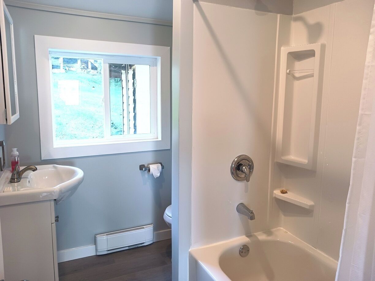 A bathroom with a sink, toilet, and bathtub.