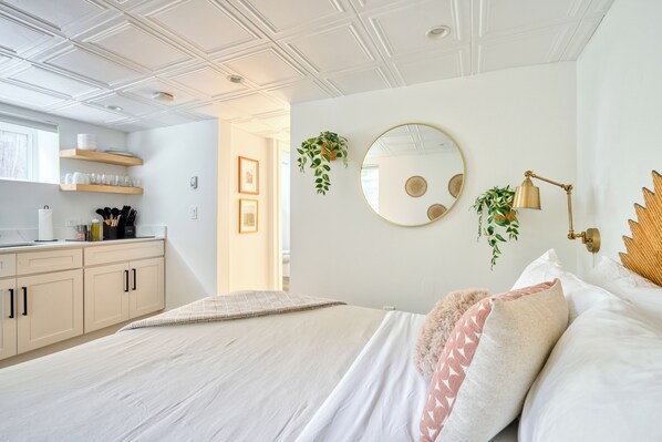 Bed beside the studio kitchenette.