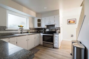 Fridge, dishwasher, coffee/tea maker, cookware/dishes/utensils