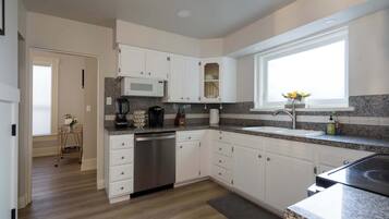 Fridge, dishwasher, coffee/tea maker, cookware/dishes/utensils