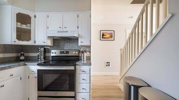 Fridge, dishwasher, coffee/tea maker, cookware/dishes/utensils