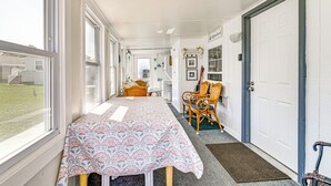 A corridor with a dining table and chairs, a door, and a view of the outside. - 1/2 Mi to Ocean: Surfside Beach Resort Home (Myrtle Beach)