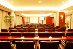 A conference room with rows of tables and chairs, a television screen, and a plant. - Ordos Aili Hotel (Beijing Jinbao Street) (Beijing)