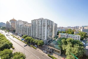 A multi-story building with a modern architectural design, featuring a prominent entrance and a visible parking area. - Ordos Aili Hotel (Beijing Jinbao Street) (Beijing)