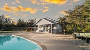 A residential property with a swimming pool, a covered patio, and a fenced backyard. - The Willows | 3 Bedrooms | 6 Guests | Heated Pool (Prince Edward)