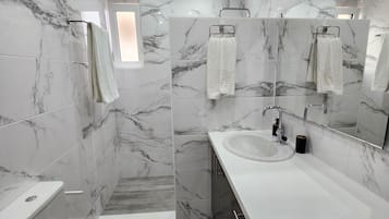 Shower, hair dryer, towels, soap