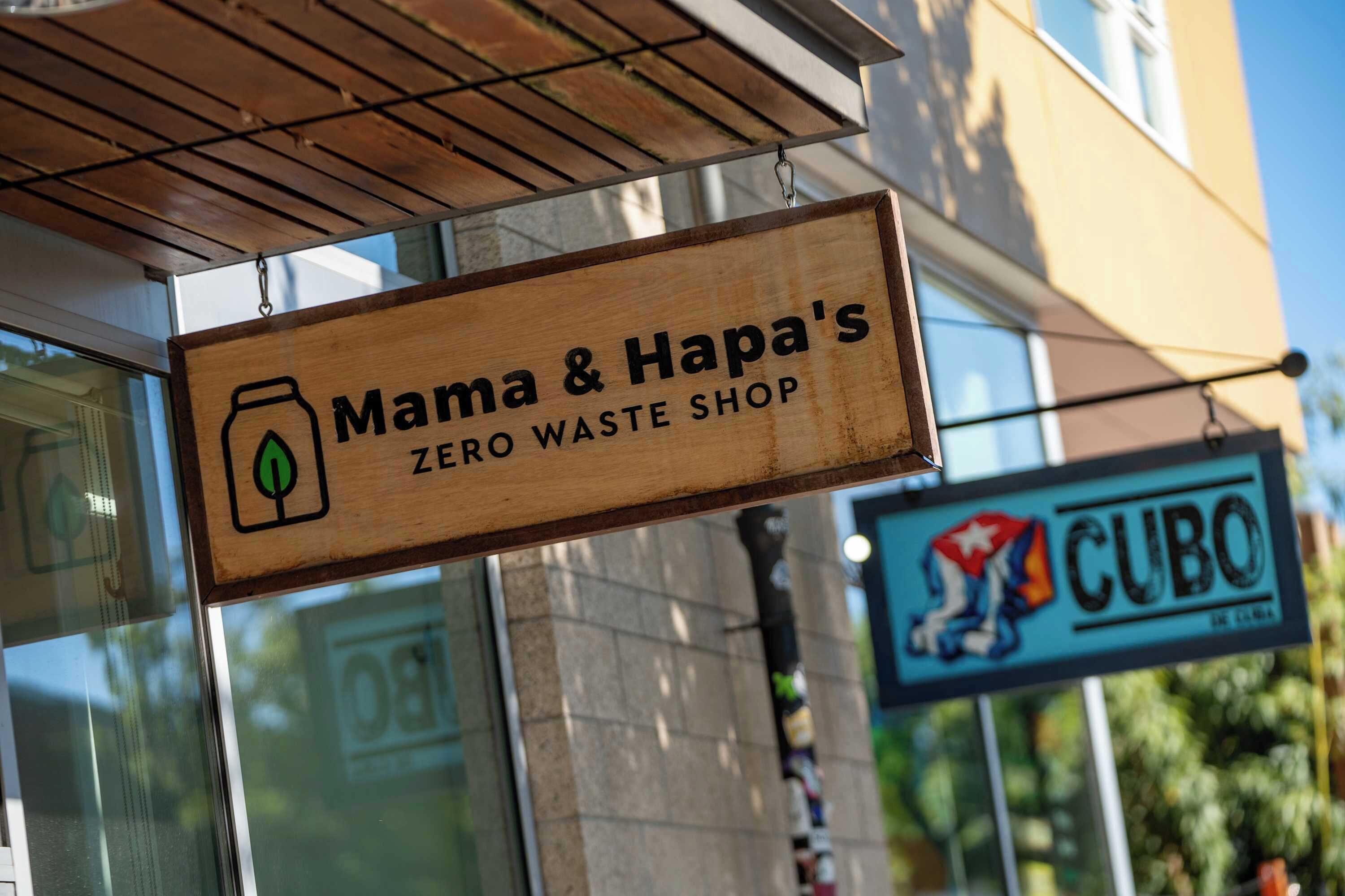 A wooden sign for Mama & Hapa's Zero Waste Shop.