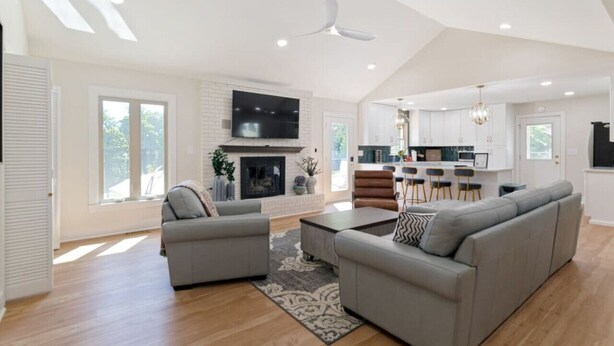 A spacious living room with a fireplace, a dining area, and a kitchen. - Poolside Paradise-Kayaks/SUPs, Private Pool, Billiards, Foosball (Winchester)