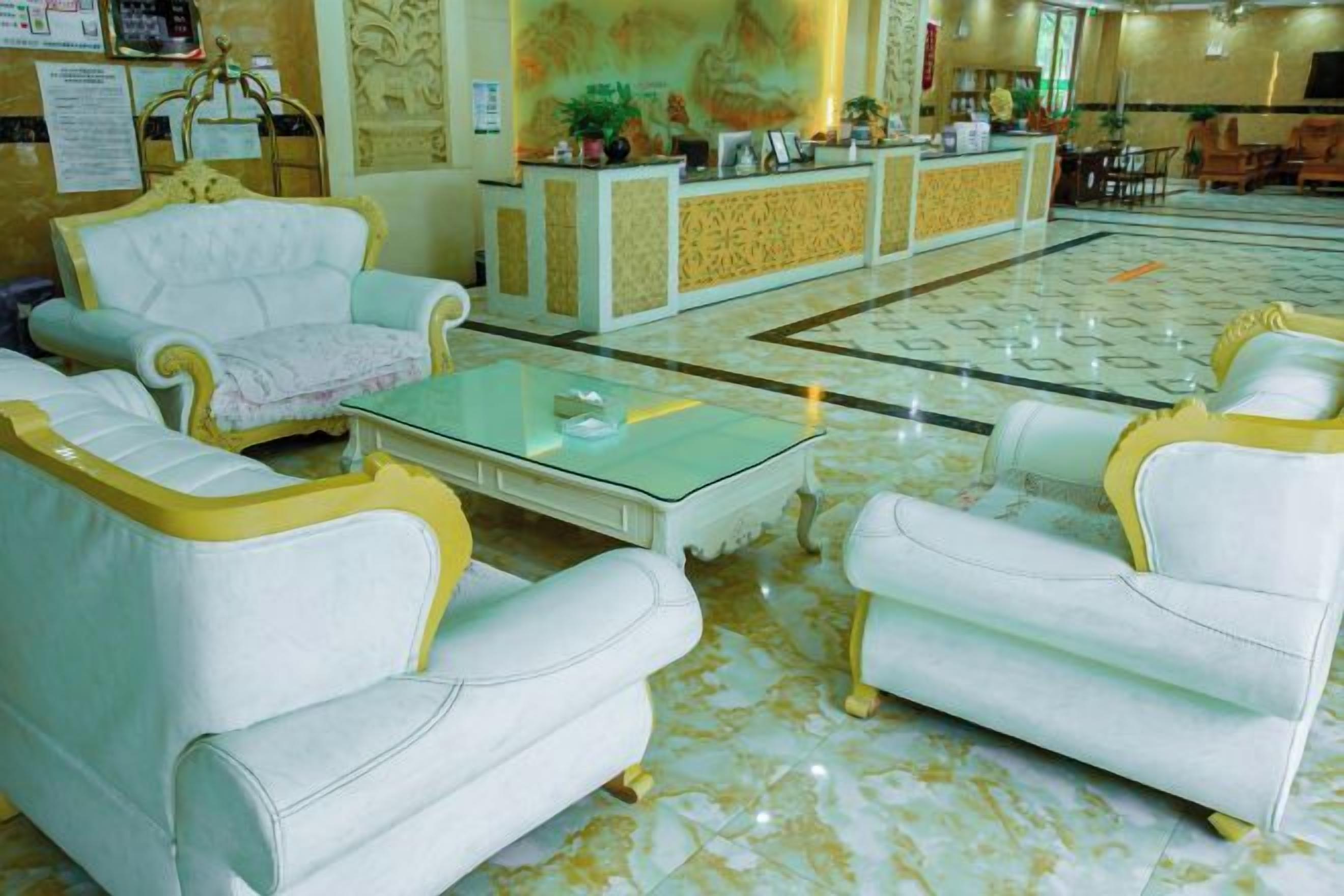 A lobby with white sofas and a reception desk.