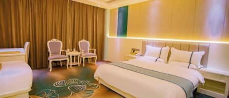 A hotel room with a bed, two chairs, a small table, a nightstand, and a curtain.