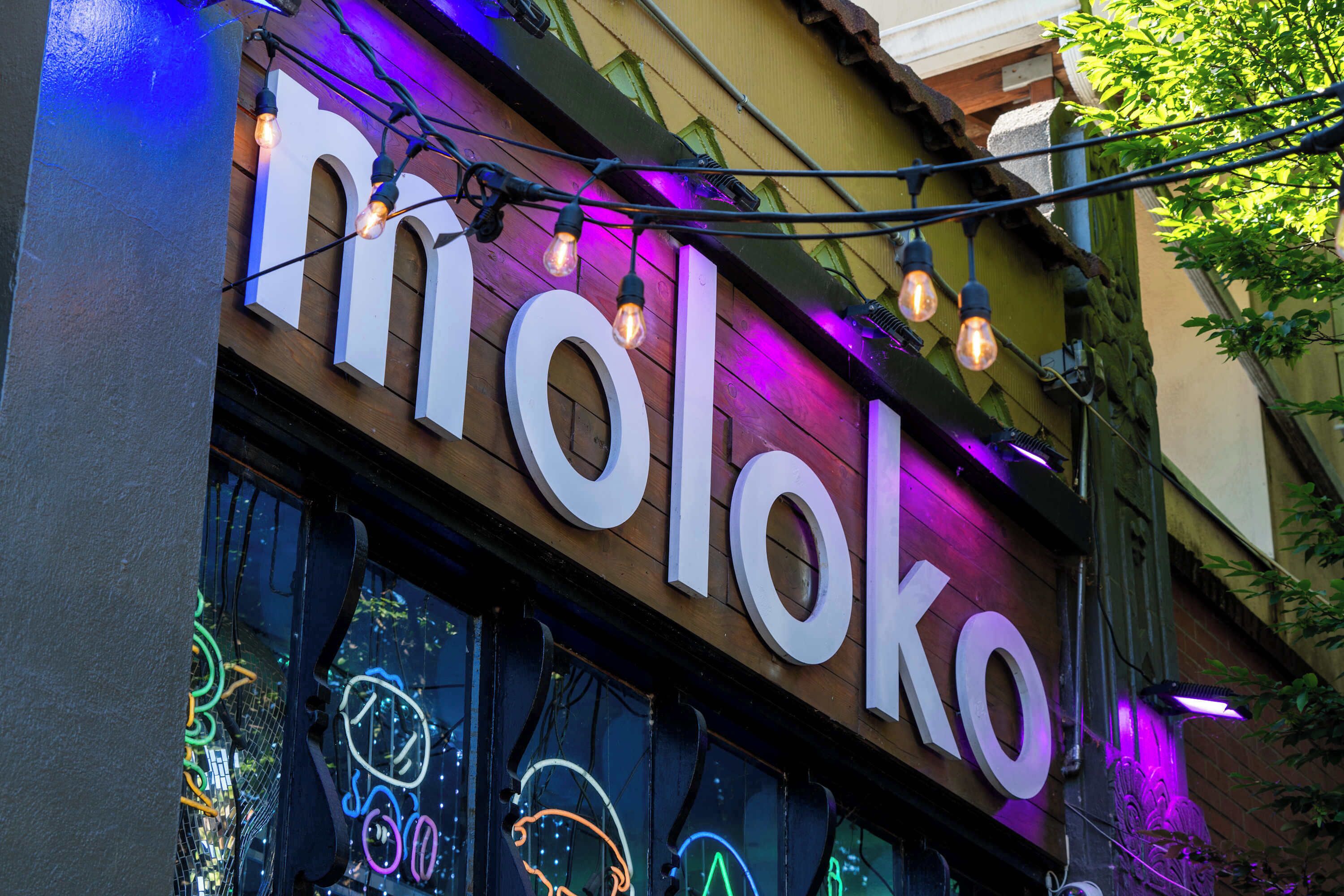 A building with a large illuminated sign reading "midloco".