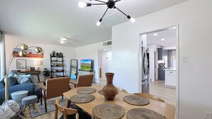 A modern dining area with a wooden table, woven placemats, and a central vase. - PAPAGO PLACE - Spacious 5-bedroom house in South Scottsdale (Scottsdale)
