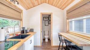 A compact kitchen with wooden countertops, a sink, and a window. - Tiny Farmhouse - Walk to Local Shops & Restaurants (Portland)
