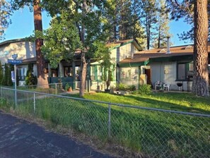 Houses with front porches and gardens line the street.